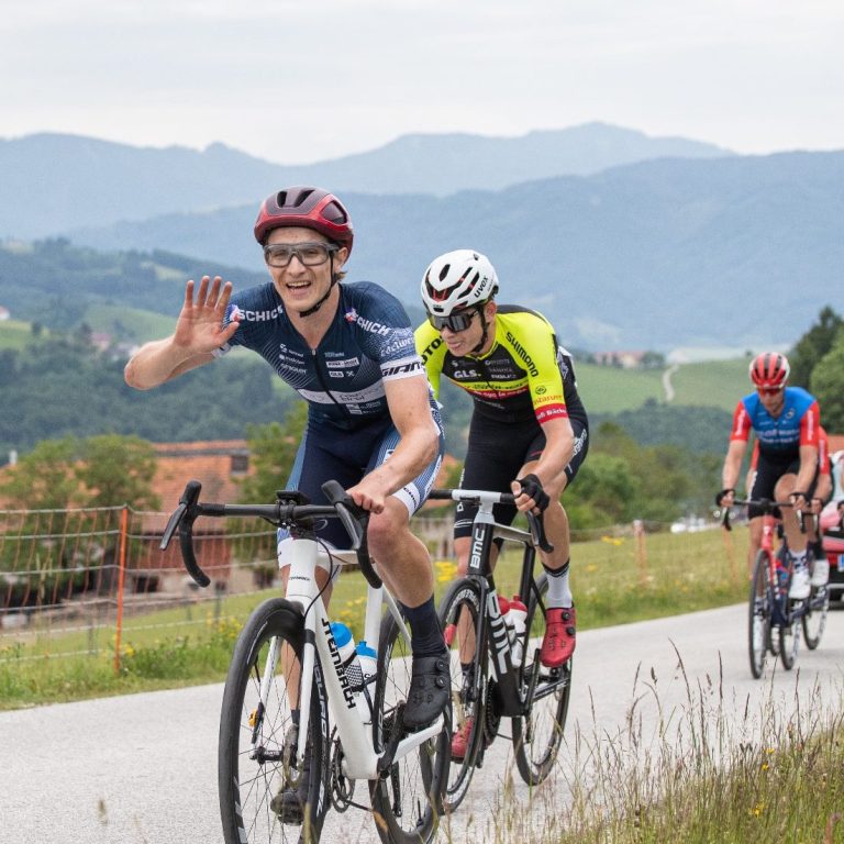 Franz waves from his bike in a race in the mountains